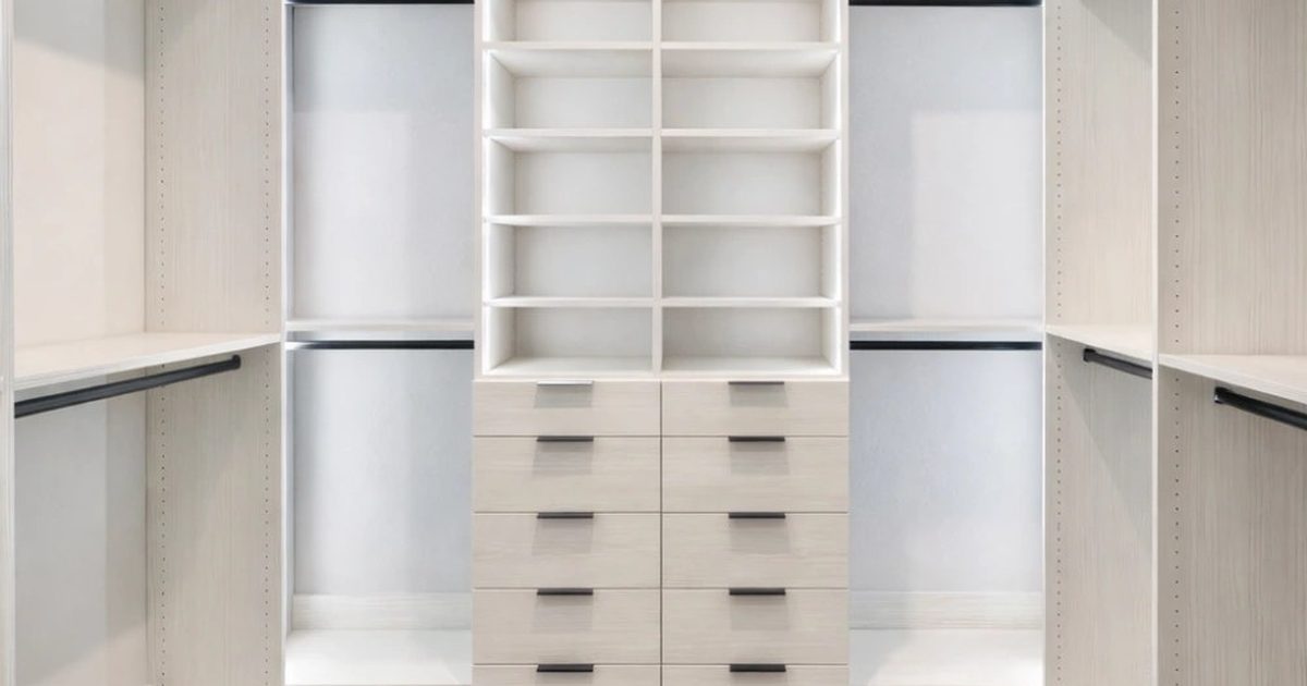 Bright custom walk-in closet with white melamine shelving, hanging rods, and a center island in an Orlando home