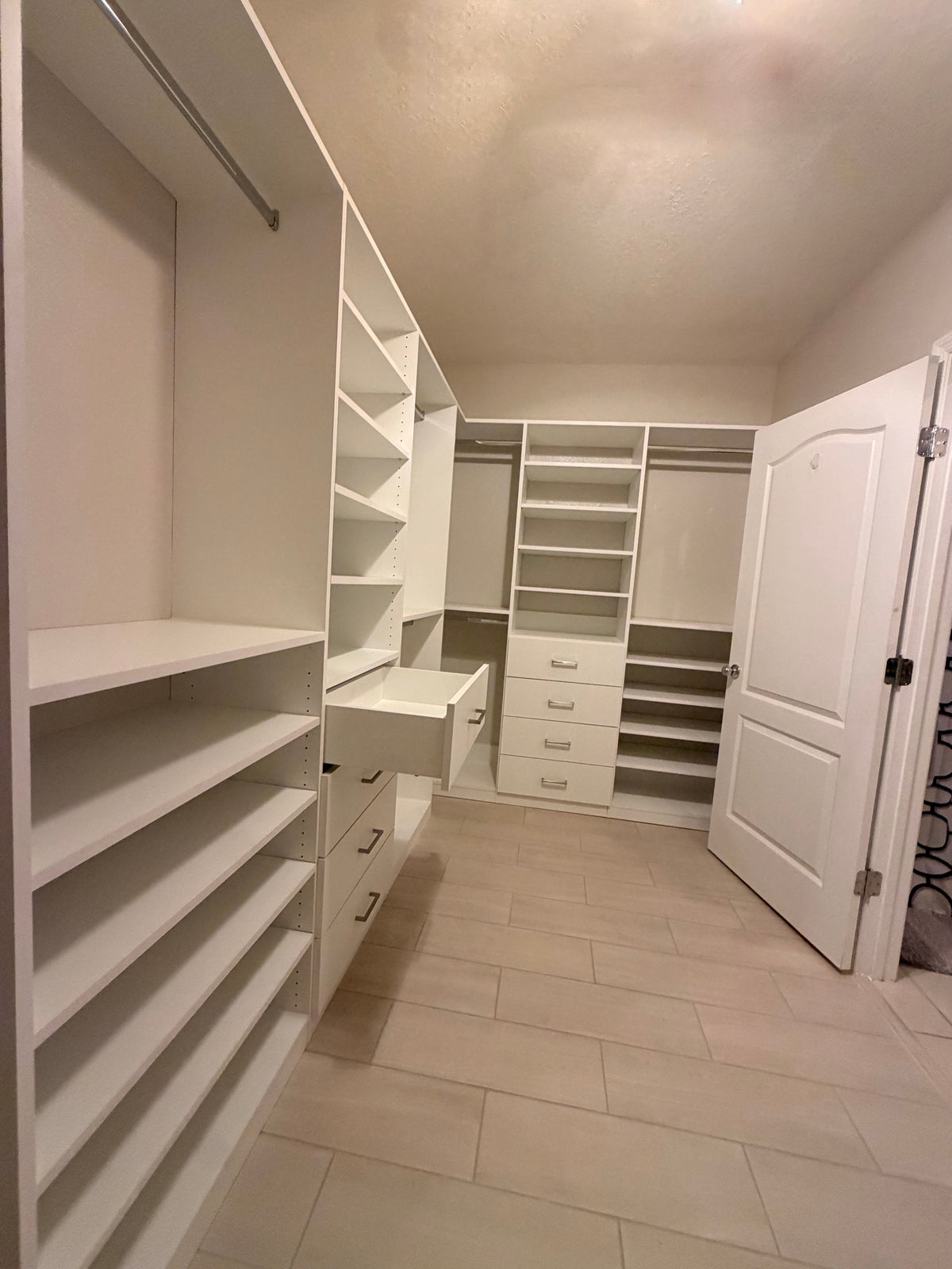 Transform your L-shaped walk-in closet into a fully organized master suite. From floor-to-ceiling shelving to smooth dra