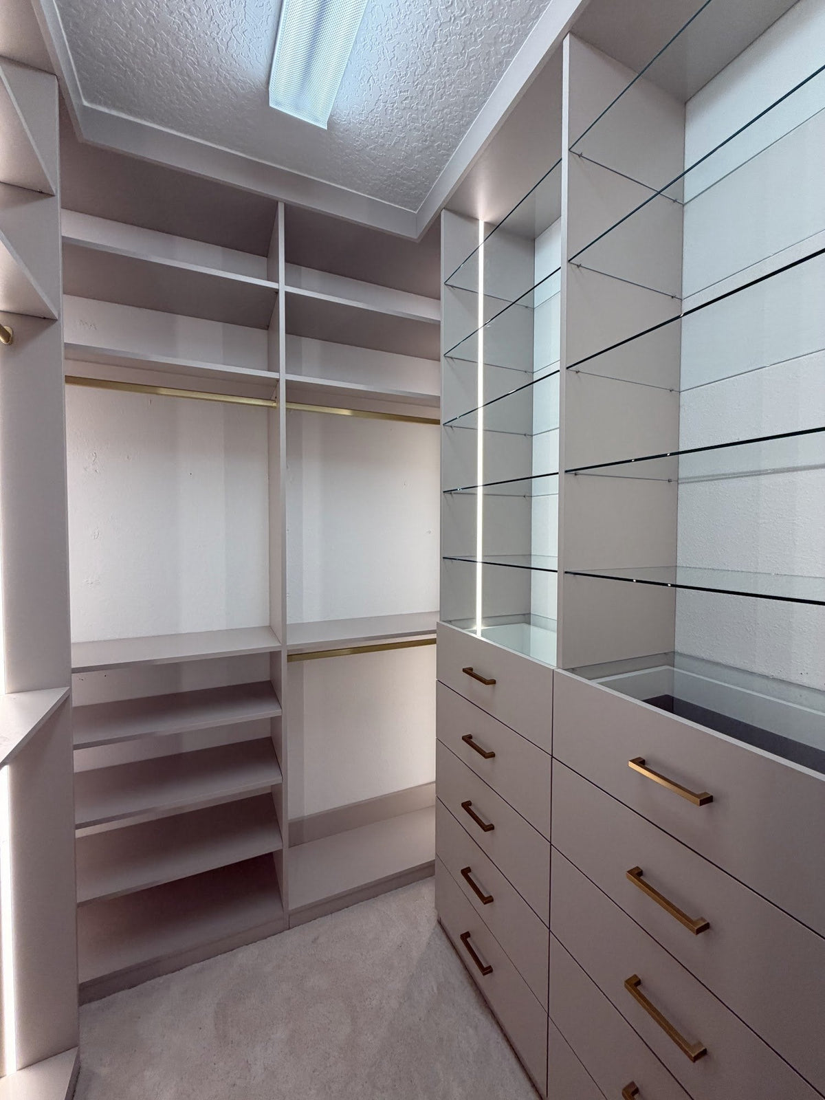 Walk-in closet with LED-lit shelving, drawers and hanging space