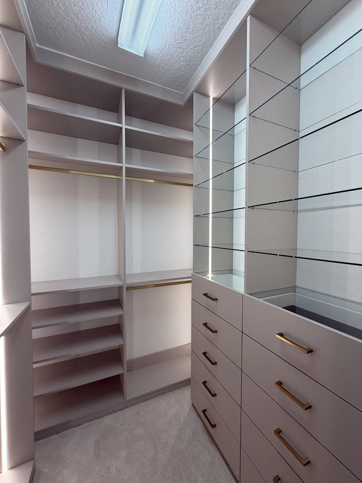 Walk-in closet with LED-lit shelving, drawers and hanging space