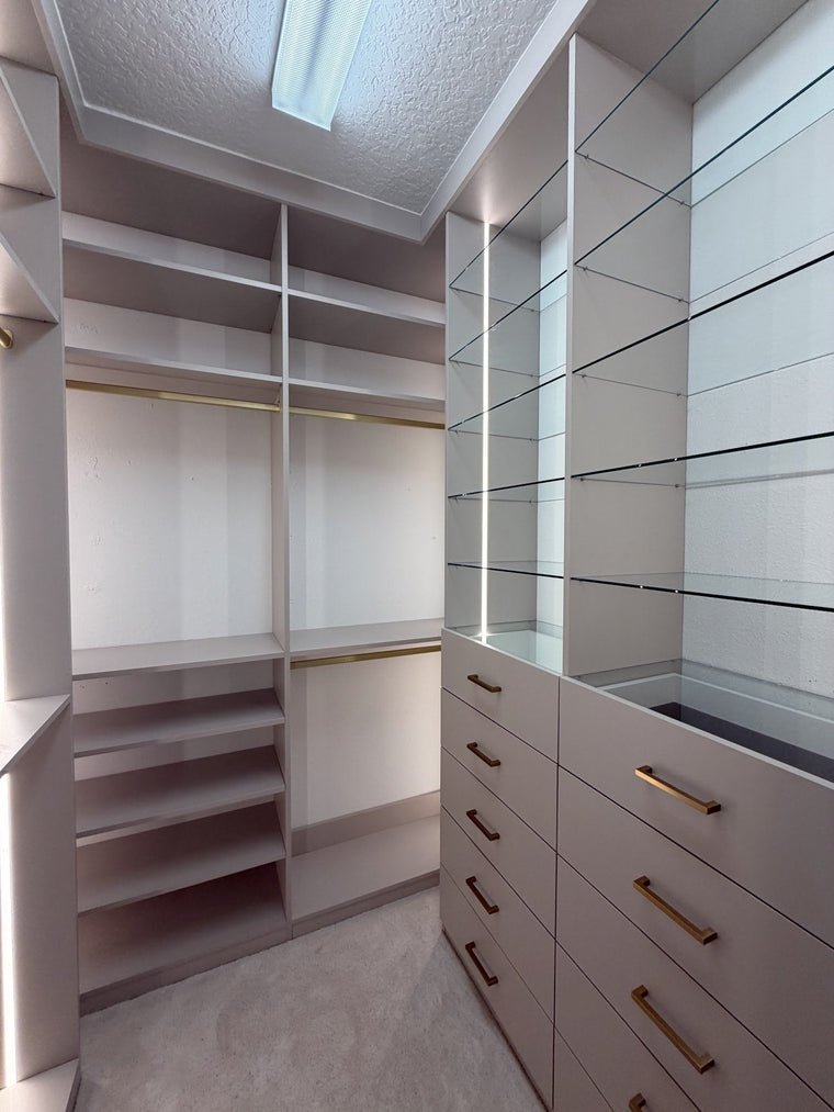 Walk-in closet with LED-lit shelving, drawers and hanging space