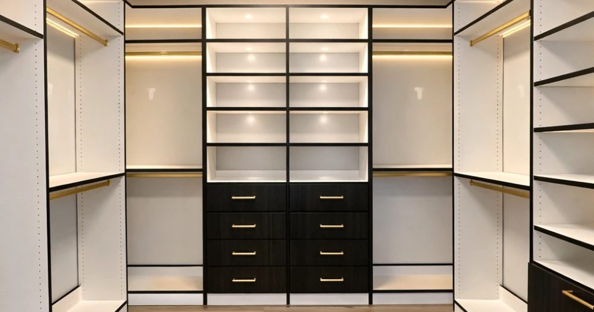 Spacious custom walk-in closet with a center island, double-hang rods, drawers, and shoe shelving