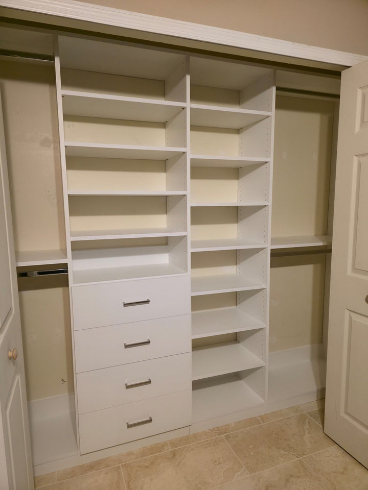 White reach-in closet with a drawer stack, adjustable shelves and double hanging
